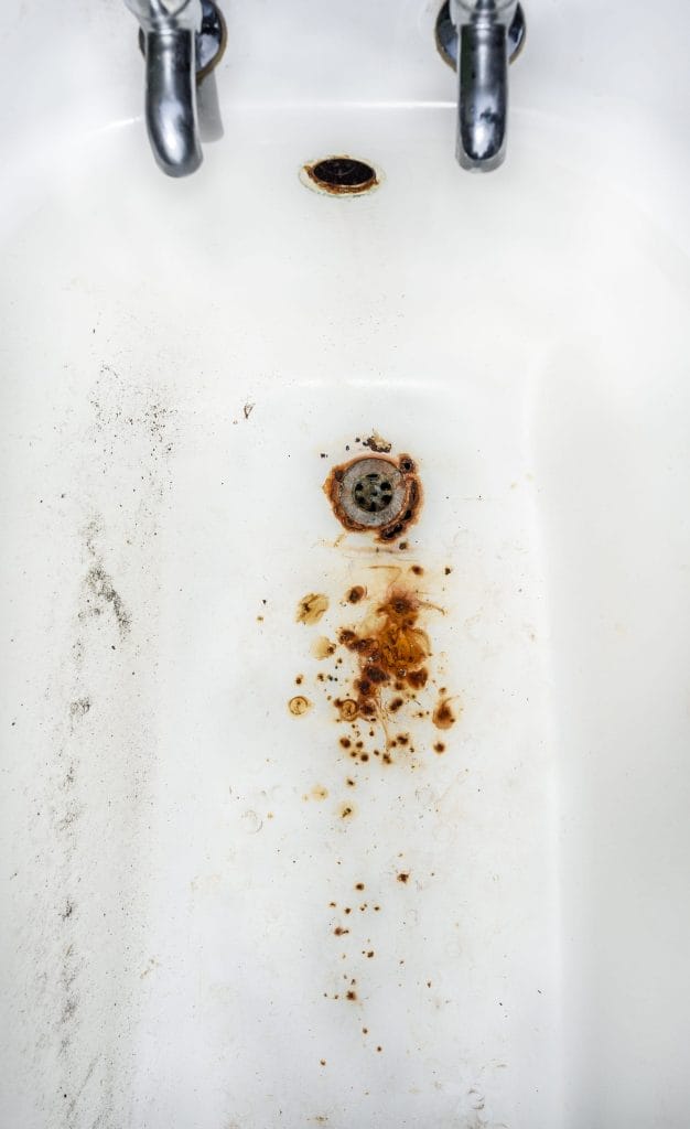 Stock image of a bathtub with staining due to high iron levels.