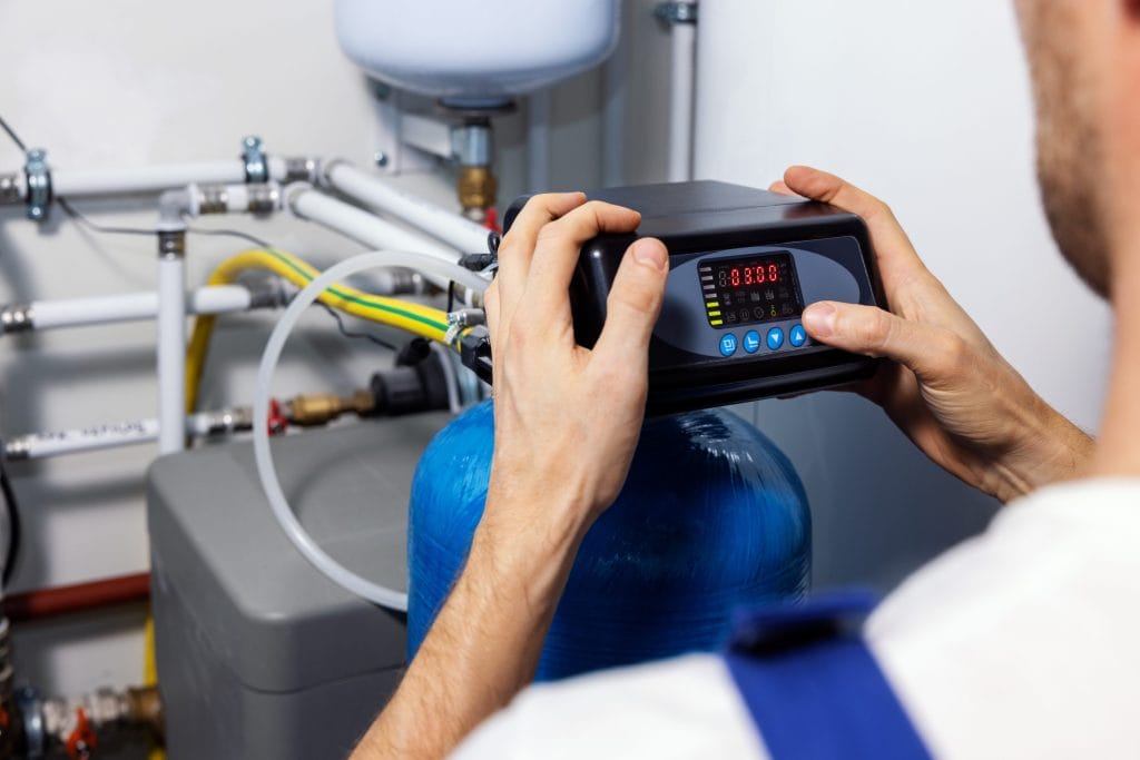 A stock image of a technician inspecting a water treatment system.